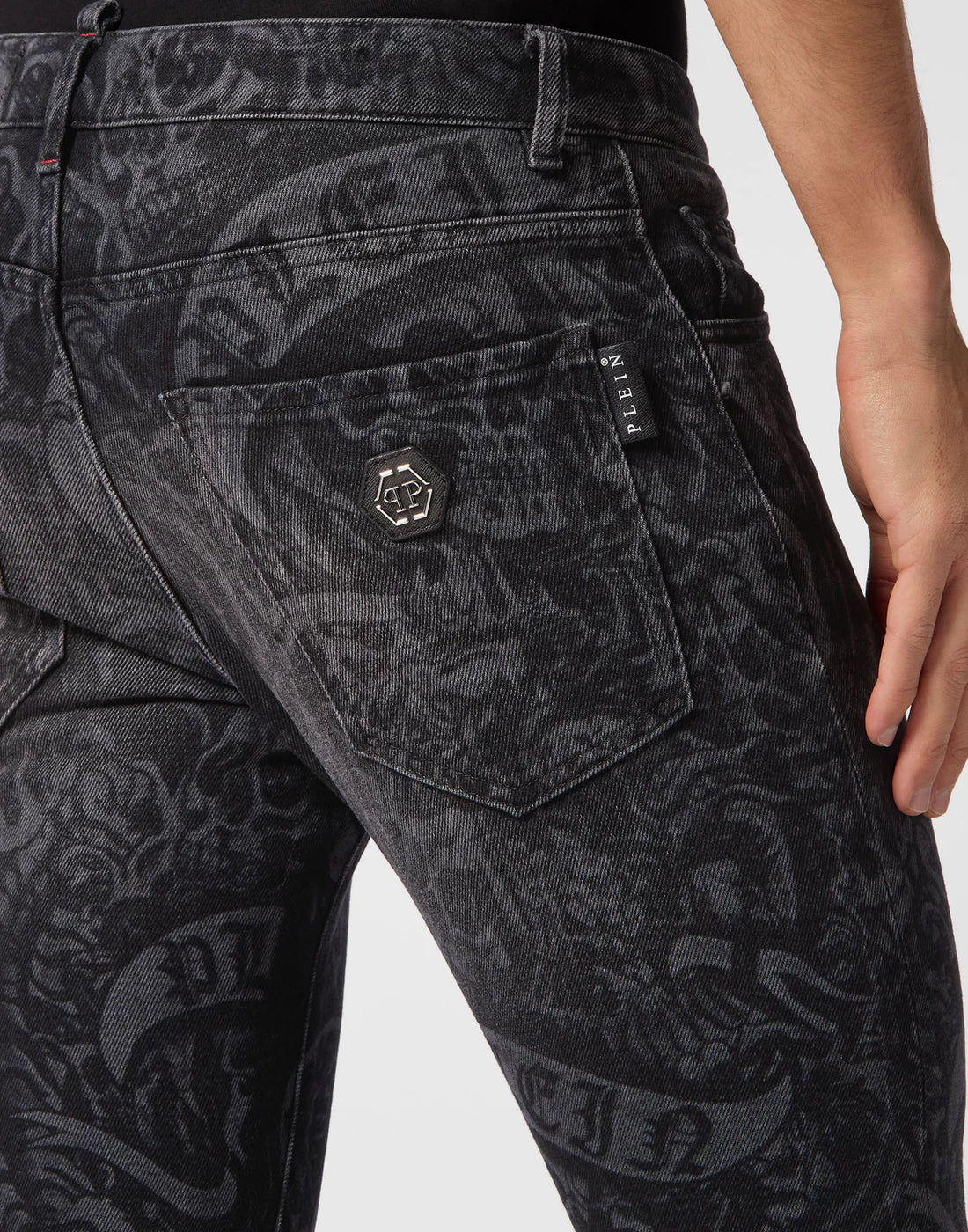 Philipp Plein black tattoo print skinny-fit denim trousers with intricate laser-printed pattern and signature branding, available at Lestyle Boutique.