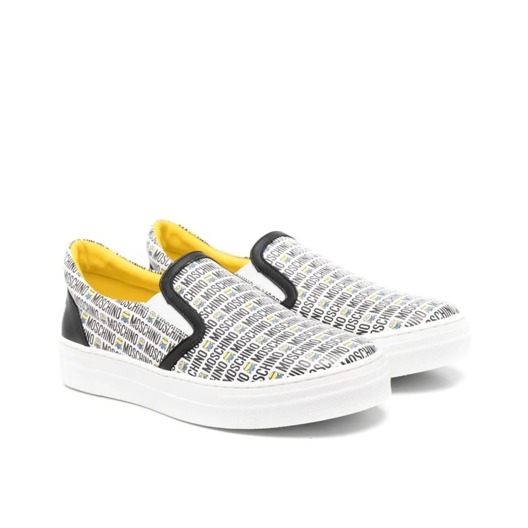 Moschino Kids white calf leather slip-on sneakers with an all-over black logo print, yellow branded insole, and white rubber sole, Made in Italy, available at Lestyle Boutique 136 Little Collins St.