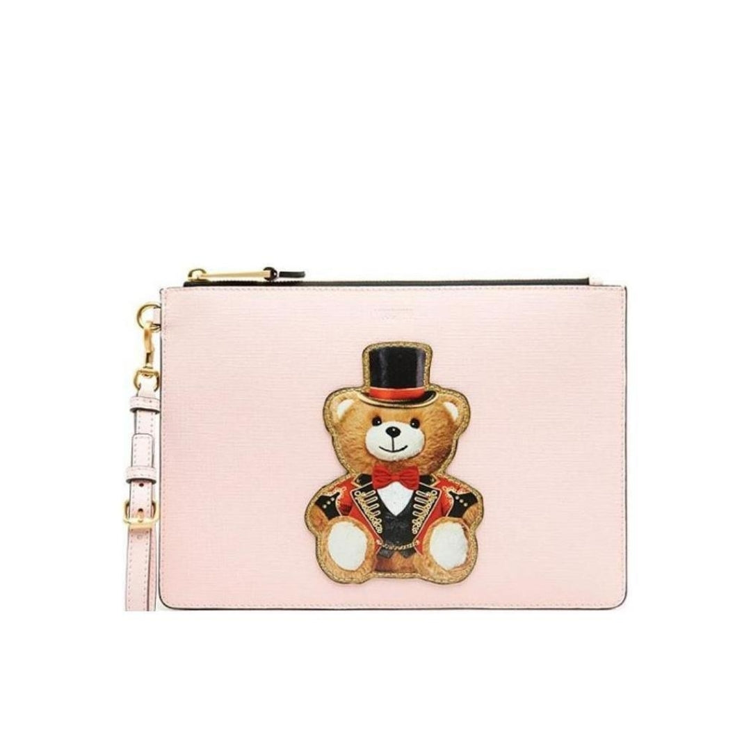 Moschino pink textured clutch featuring a multicolor Circus Teddy Bear print, top zip closure with gold-tone hardware, and a detachable wrist strap, available at Lestyle Boutique 136 Little Collins St.