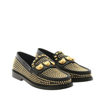 Moschino women's black calfskin leather loafers covered in golden metal studs, featuring a gold-tone Teddy Bear applique on the vamp and a cowhide leather sole, available at Lestyle Boutique 136 Little Collins St.