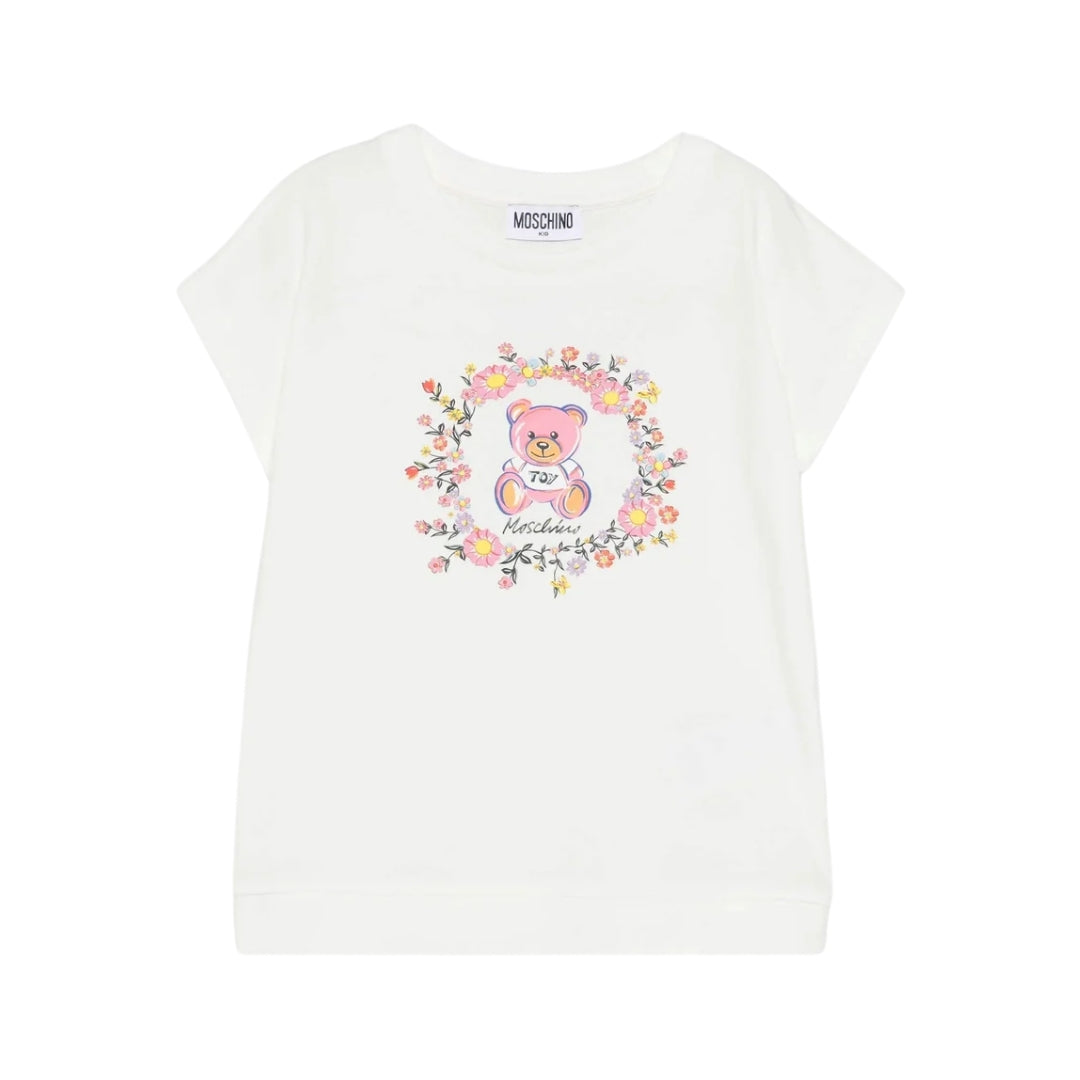 Moschino Kids girls' ivory cotton-blend t-shirt with round neck and short sleeves, featuring a Teddy Bear print surrounded by a floral wreath on the chest, available at Lestyle Boutique 136 Little Collins St.