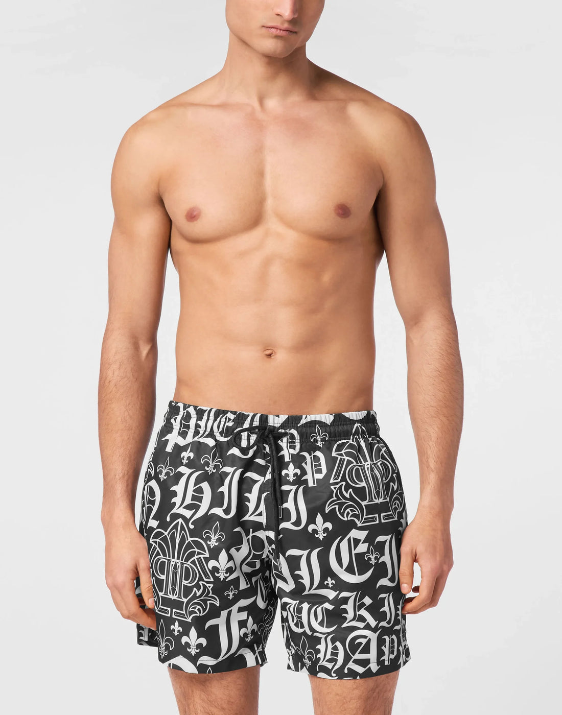 Philipp Plein black nylon jogging shorts with an all-over white Gothic print, elasticated drawstring waistband, and a rubber PP Hexagon patch, available at Lestyle Boutique 136 Little Collins St.