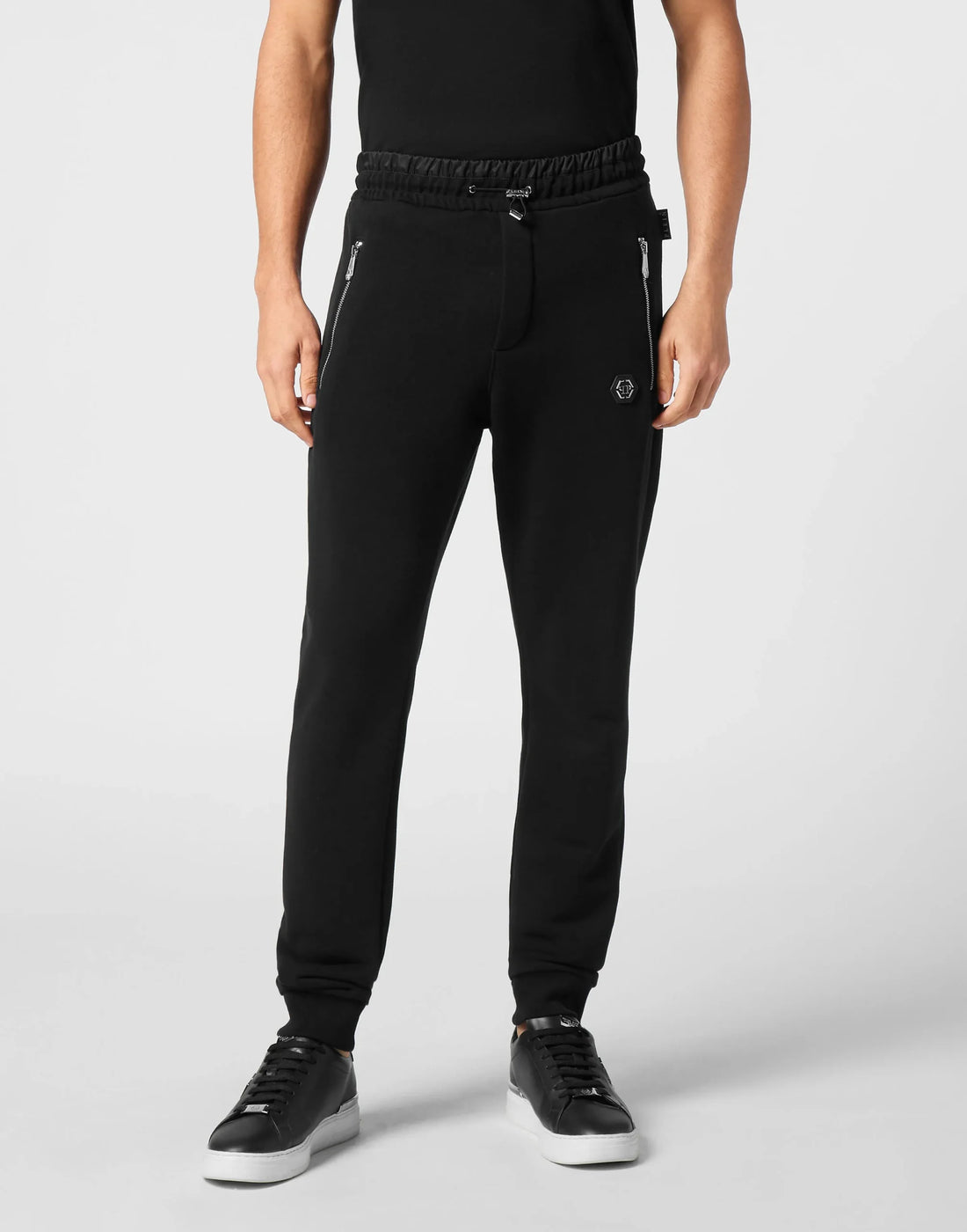Philipp Plein black puffered jogging pants with a cotton-blend fleece construction, featuring zip-up pockets and ribbed cuffs, available at Lestyle Boutique.