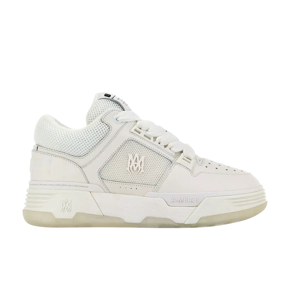A pair of all-white MA-1 low-top sneakers by AMIRI, available at Lestyle Boutique. Featuring a leather upper, mesh panels, and signature "MA" logo detailing, these sneakers offer a refined and modern look.
