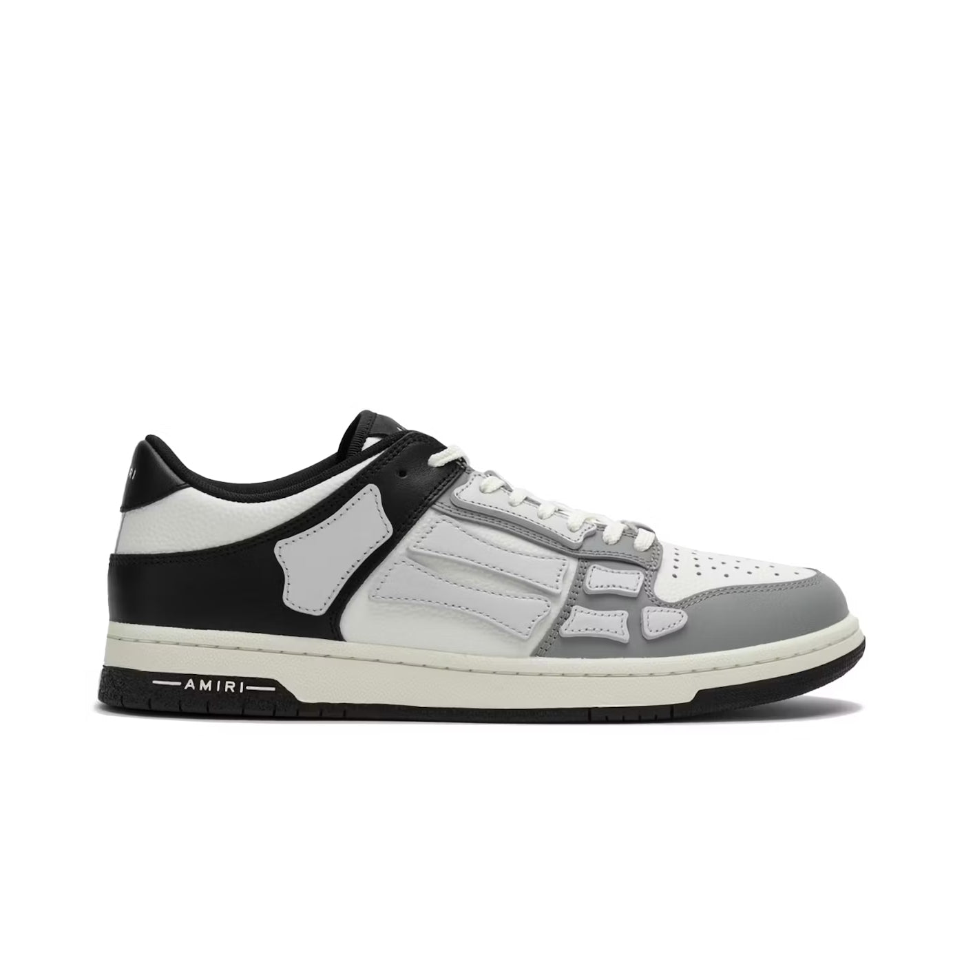 A stylish low-top leather trainer by AMIRI, available at Lestyle Boutique. Featuring a black, white, and grey colour scheme, these trainers include a perforated round toe, lace-up fastening, and durable rubber sole for both style and comfort.
