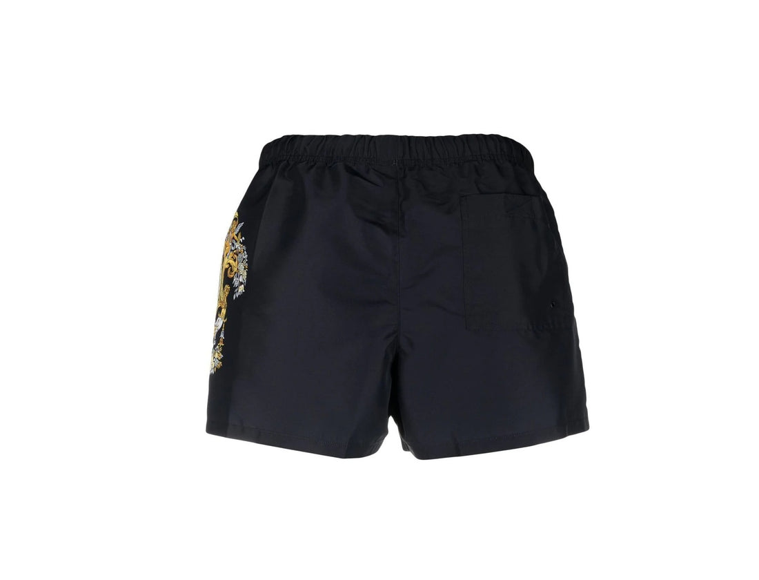 Versace swim shorts in black with multicolour baroque logo print on the side, featuring a drawstring waist and rear patch pocket, available at Lestyle Boutique 136 Little Collins St.
