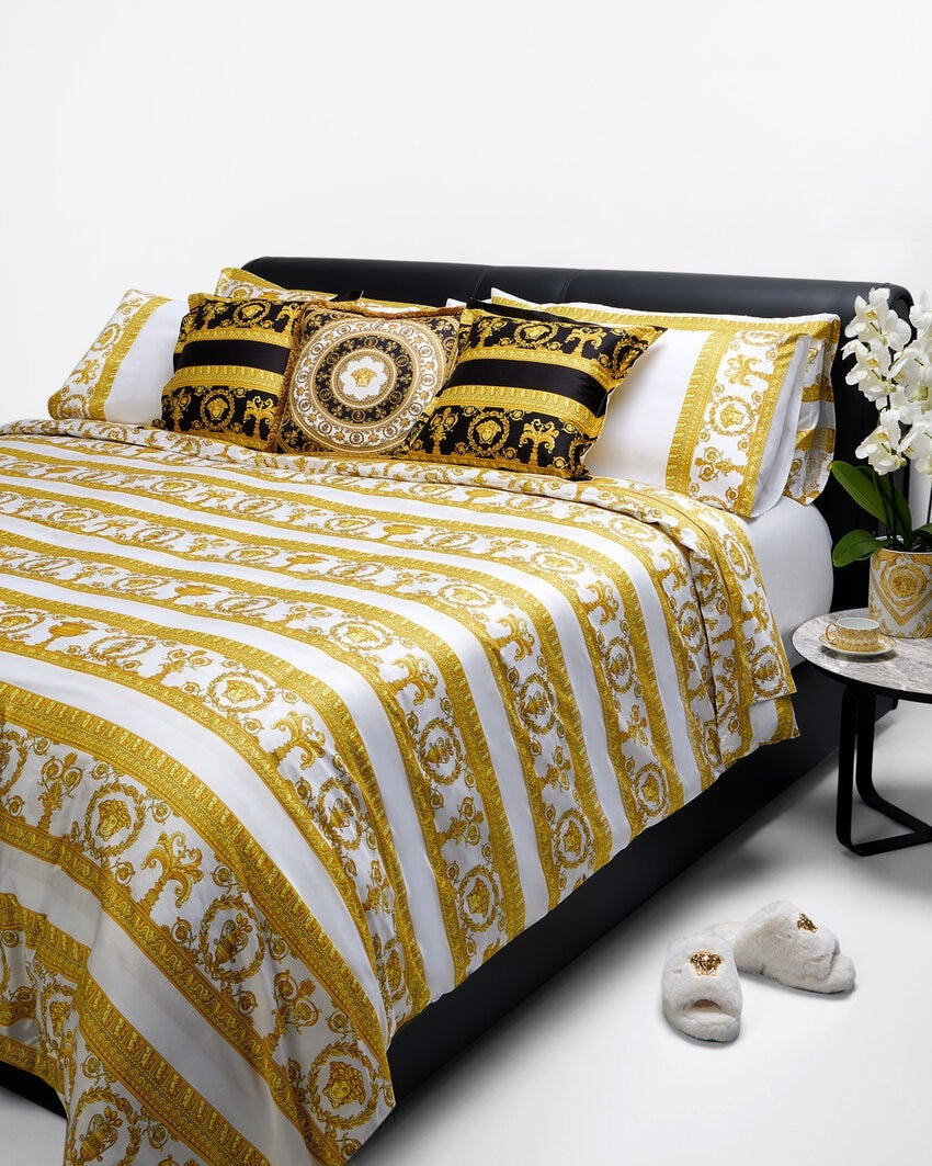 Folded fabric with gold and white pattern on a white background, available at Lestyle Boutique 136 Little Collins St.