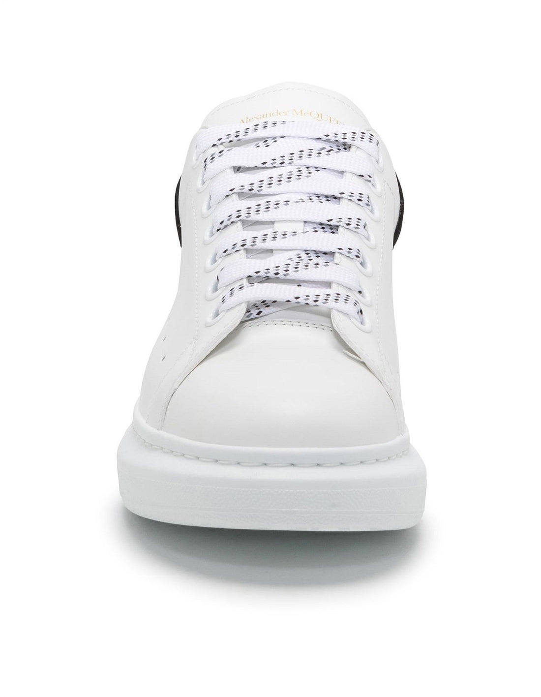 White sneaker with black heel tab on a white background