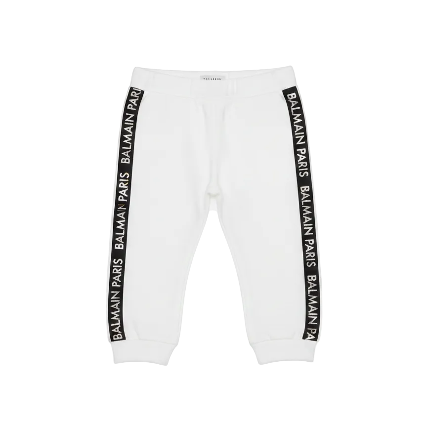 White sweatpants with Balmain logo stripes on a white background
