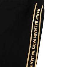 Luxury Balmain kids black track pants featuring a stylish logo tape design along the sides. These premium pants are crafted from high-quality materials, ensuring comfort and durability for active children. The modern fit and sleek design make them perfect for casual outings or playdates, providing both style and functionality. Ideal for young fashion enthusiasts, available at Lestyle Boutique Melbourne.