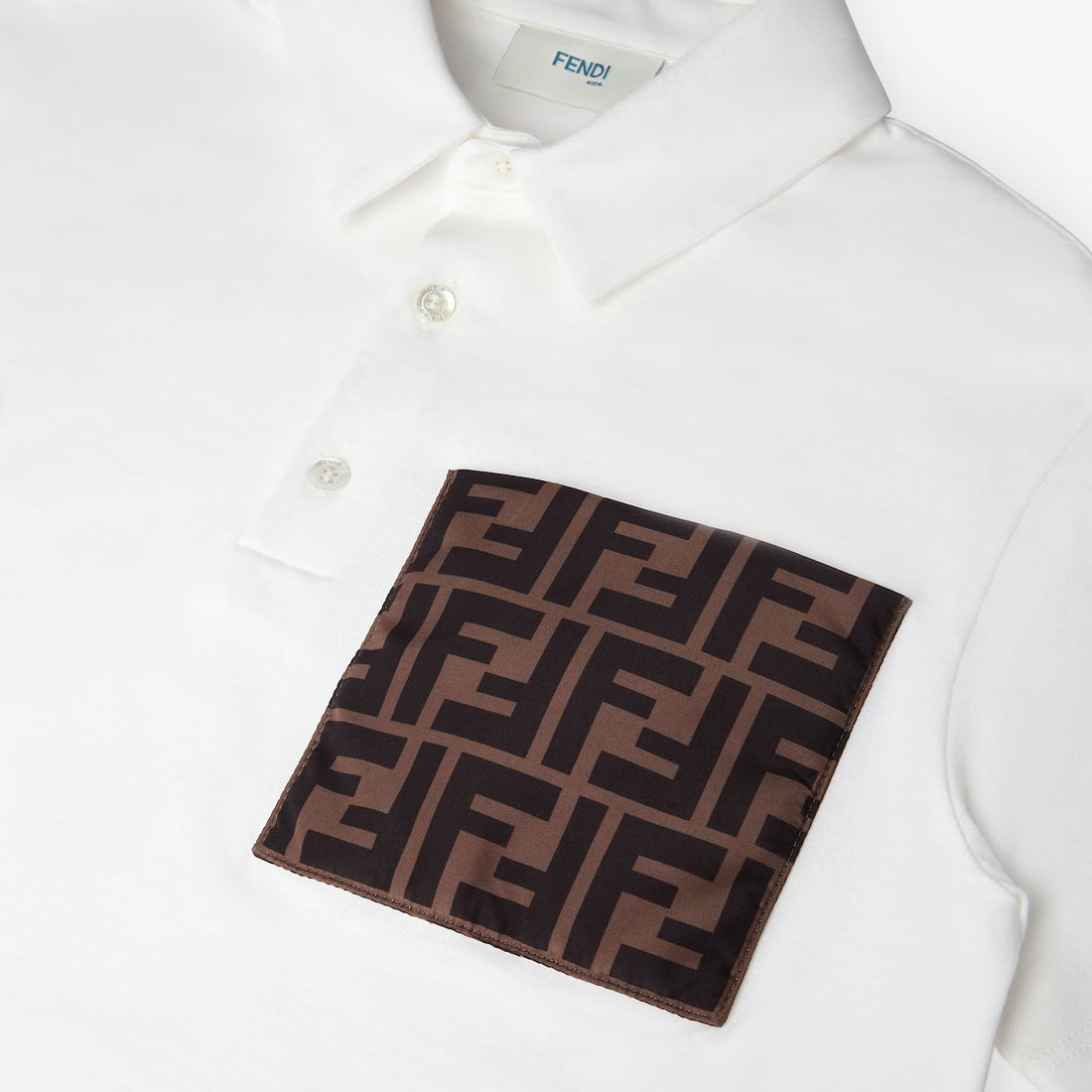 Fendi junior white polo shirt with FF logo pocket, available at Lestyle Boutique.