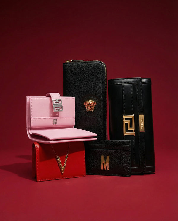 Collection of pink and black wallets with decorative elements on a red background