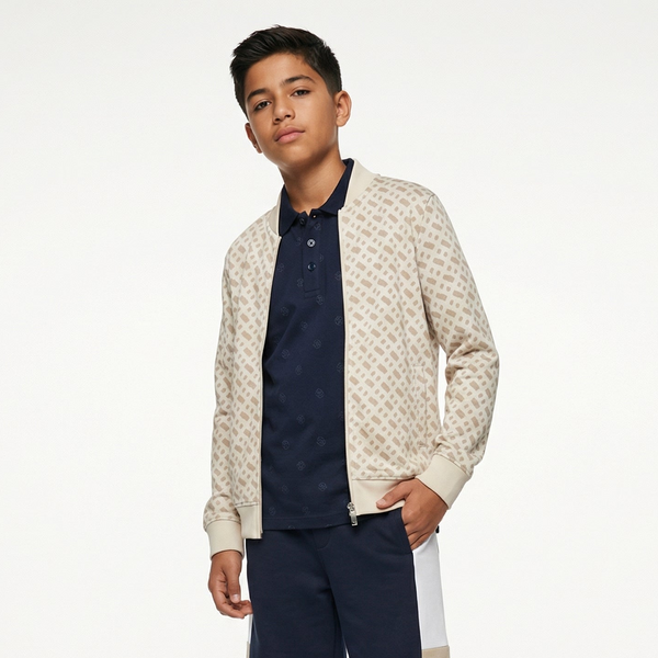 Person wearing a patterned bomber jacket over a navy shirt and pants on a white background