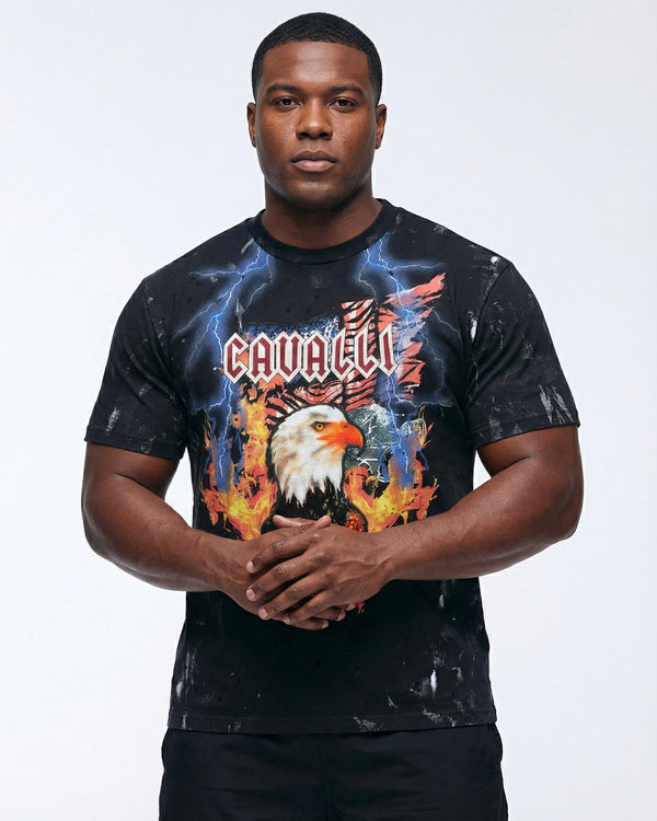 Man wearing a black t-shirt with a colorful graphic design featuring an eagle and the word 'Cavali'.