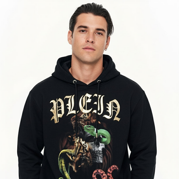 Man wearing a black philipp plein hoodie with graphic design and text on a white background