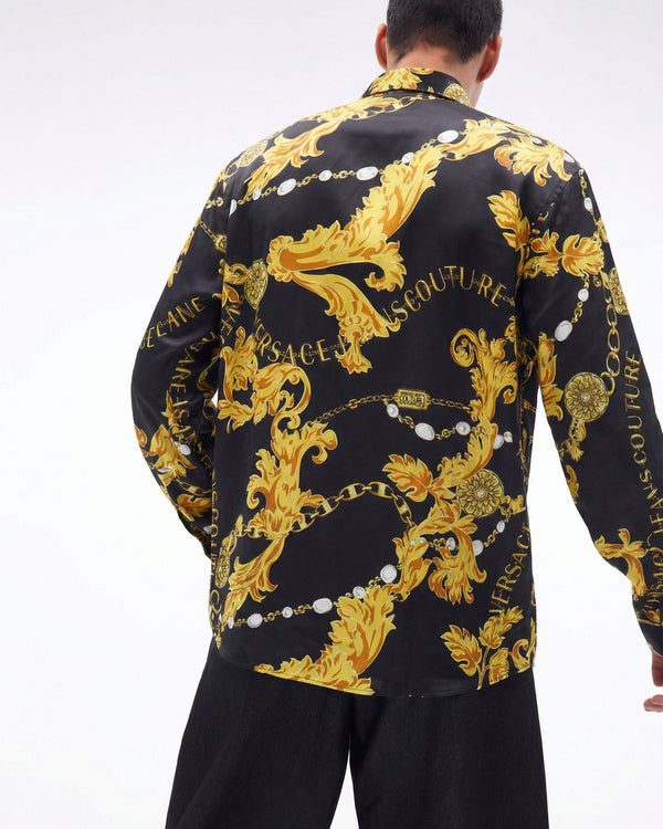 Black shirt with gold baroque pattern and 'Versace' branding on a white background