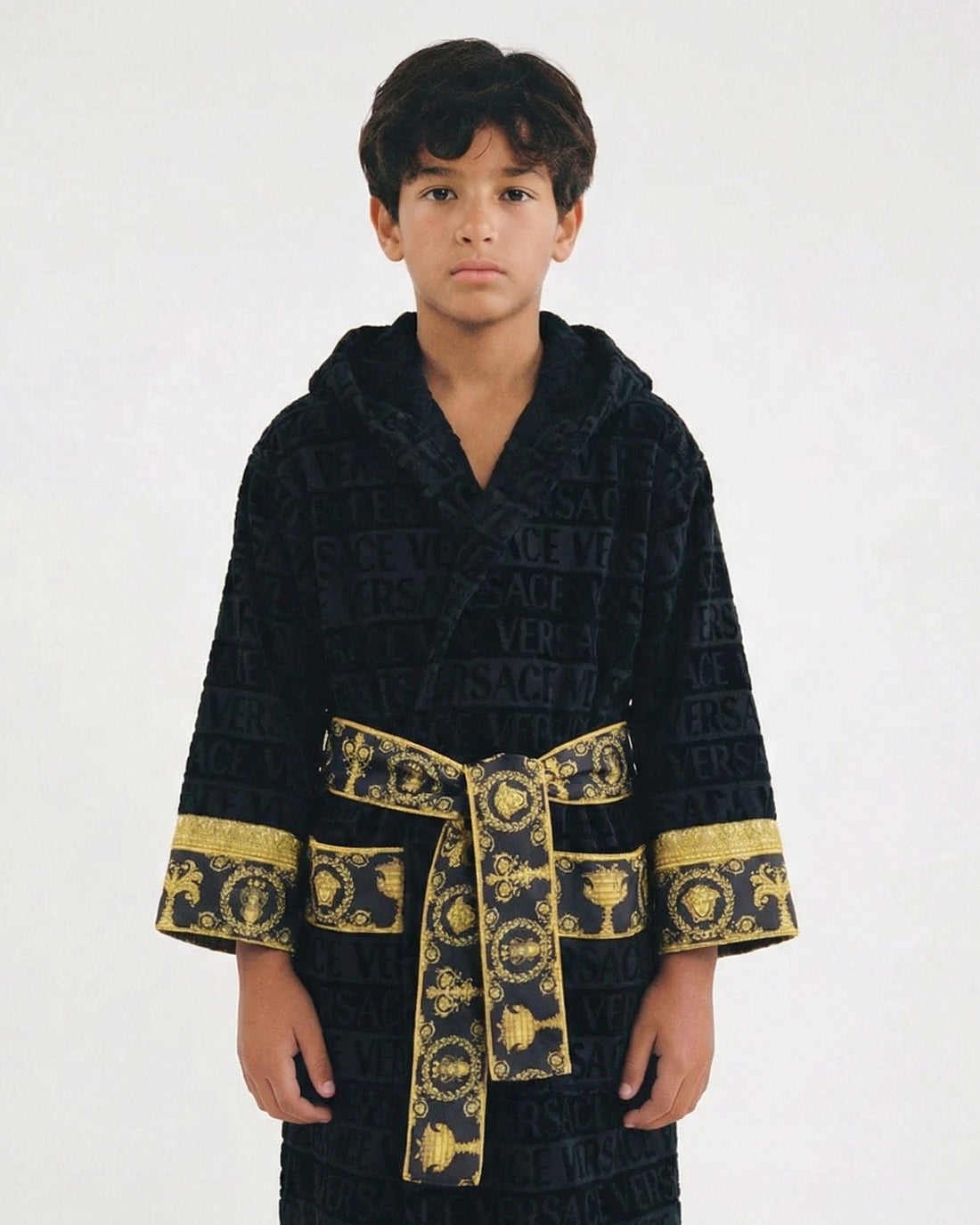 Versace Kids I Love Baroque Hooded Bathrobe in black with gold baroque detailing, featuring an all-over logo print, hooded design, and belted waist, available at Lestyle Boutique.