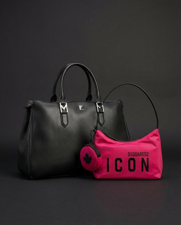 Black handbag and pink pouch with 'Dsquared2' branding on a dark background