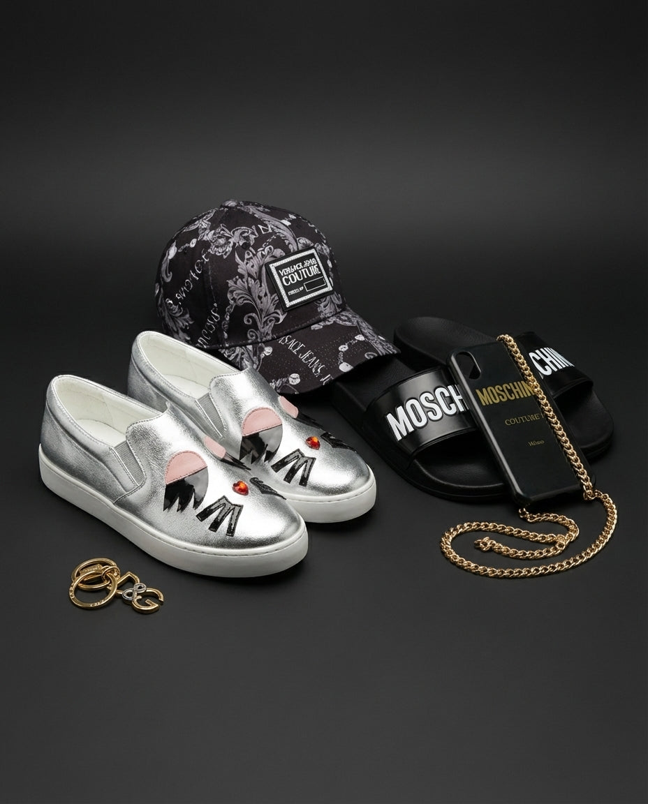 Silver shoes, black cap, black slides with gold chain, and gold ring on a dark background