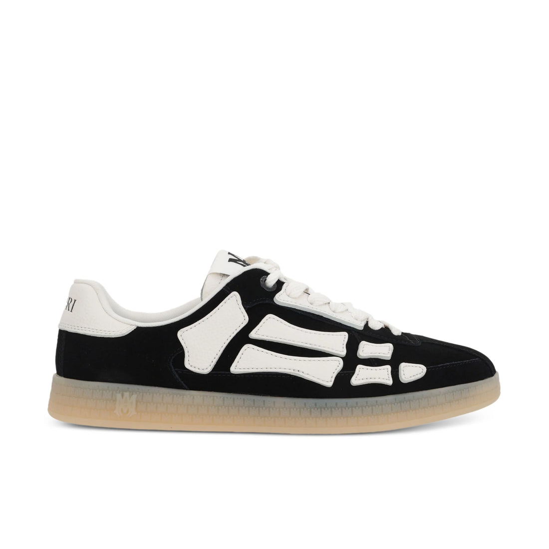 A pair of black Pacific Bones low-top sneakers by AMIRI, available at Lestyle Boutique. These sneakers feature a suede upper with skeleton motif overlays, leather applications, and a durable rubber sole with MA icon detailing.