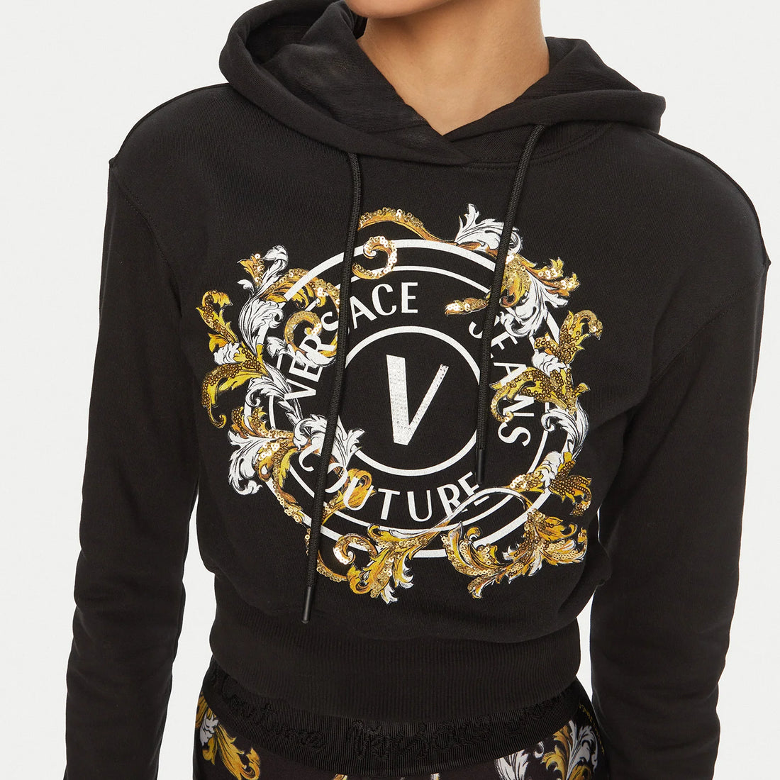 Versace Jeans Couture Black Sweatshirt with baroque "V" logo print and shimmering sequins, ideal for chic streetwear looks, available at Lestyle Boutique.