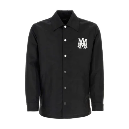 A sleek and lightweight black jacket by AMIRI, available at Lestyle Boutique. The jacket showcases embroidered logo details on both the chest and back, made from durable 100% nylon for a timeless look.