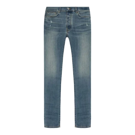 A pair of blue skinny jeans by AMIRI, available at Lestyle Boutique. These low-rise jeans feature a stretch construction, faded detailing, whiskering effects, and a classic five-pocket design for a modern and sleek fit.