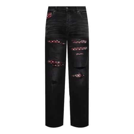 A pair of black distressed jeans by AMIRI, available at Lestyle Boutique. These jeans feature unique bandana inserts, a straight-leg fit, concealed button fastening, and a classic five-pocket design.