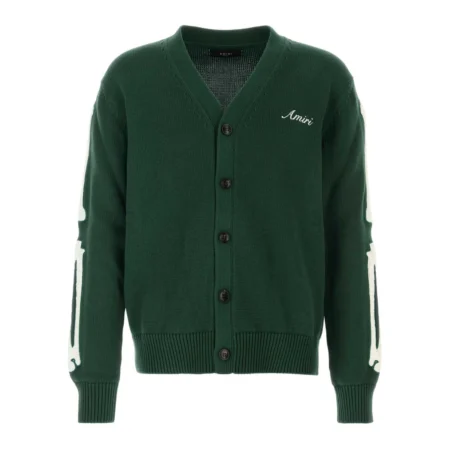 A forest green cotton cardigan by AMIRI, available at Lestyle Boutique. This cardigan features bone embroidery on the sleeves, a V-neck, front button fastening, and ribbed detailing for a stylish and contemporary look.