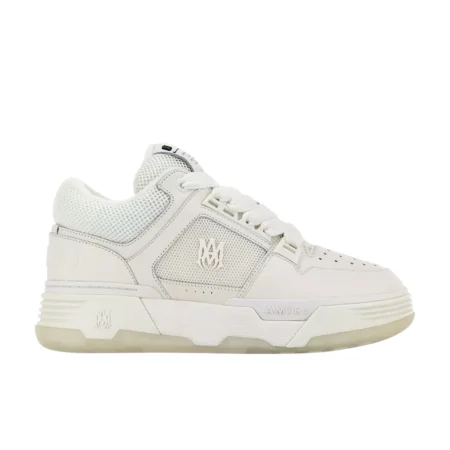 A pair of all-white MA-1 low-top sneakers by AMIRI, available at Lestyle Boutique. Featuring a leather upper, mesh panels, and signature "MA" logo detailing, these sneakers offer a refined and modern look.
