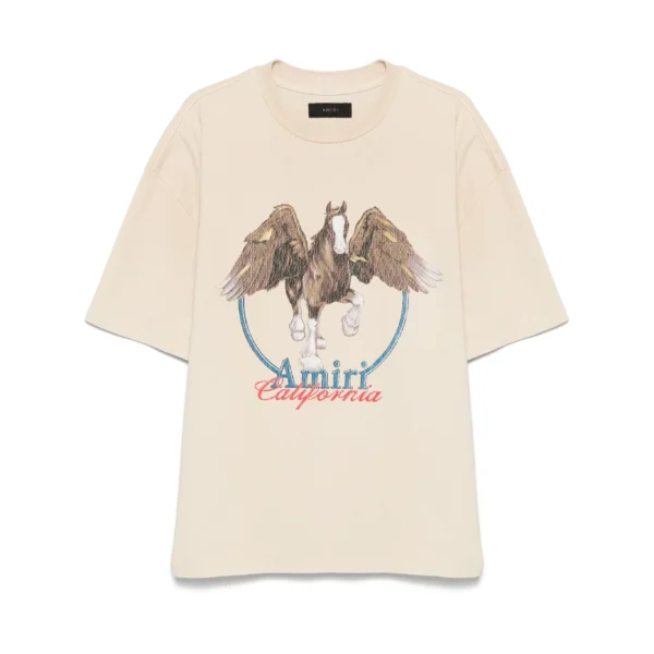 An alabaster vintage wash t shirt by AMIRI available at Lestyle Boutique Featuring a bold Pegasus print and Amiri California logo this tee offers a unique retro inspired style